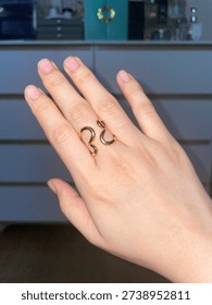 Open gold ring with unique shape similar to butterfly wings 