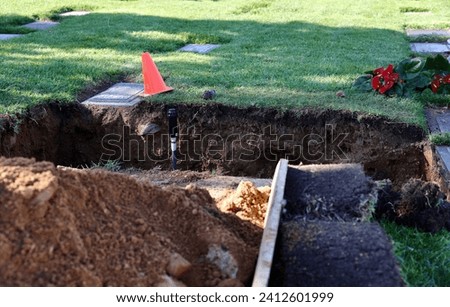 Open grave at the cemetery in preparation for the burial