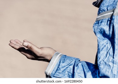 Open Hand Of A Traditional Dressed Moroccan Man. High Key Image With Muted Colors.