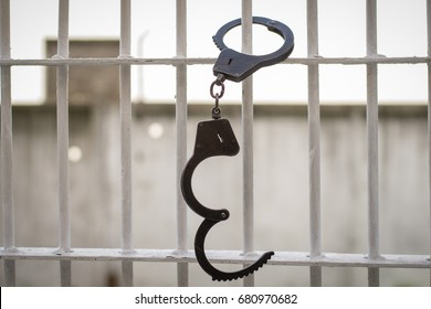 Open handcuffs hang on the cage. Successful escape exemption