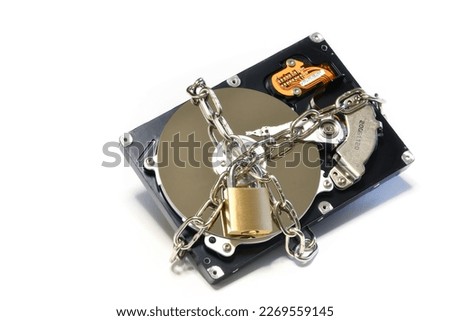 Open hard drive secured with an iron chain and padlock. Cyber ​​security concept. Data of hard drive secured by padlock