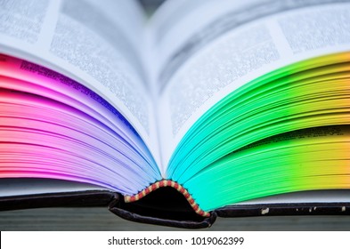 Open Hardcover Book. Leaves Of Rainbow Colors.