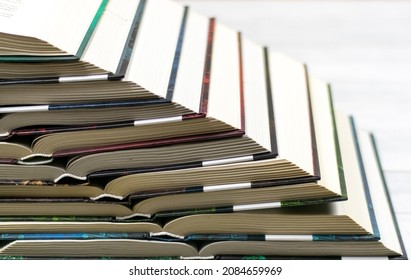open hardcover books are stacked vertically on top of each other. The concept of loving books, reading books