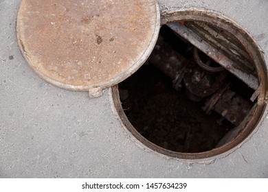 Open Hatch With Cover On The Asphalt Road. Top View Of The Sewer. Danger To People. Underground Pipeline Repair.