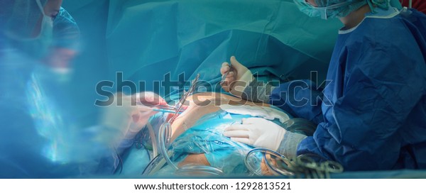 open heart cardiac surgery in\
hospital cardiovascular microsurgery with minithoracotomy\
procedure, surgeon operating beating heart surgery with his medical\
team