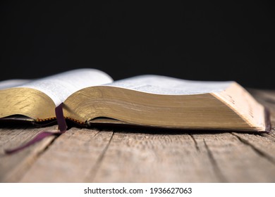 Open Holy Bible on the wooden table - Shutterstock ID 1936627063