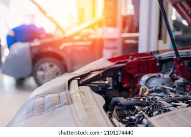 Open Hood And Disassembled Engine In Car Service With Sun Light. Concept Maintenance And Oil Change.