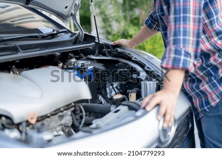 Open hood mechanic engine system to check and repair damage car crash.