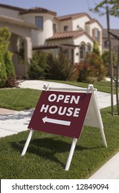 Open house sign, indicating new home to  look at, sign is sharp focus falls off in the background