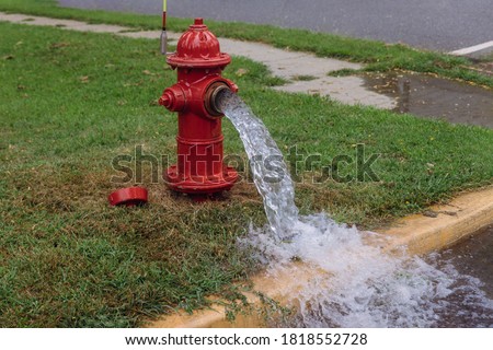 Open industrial fire hydrant being sprayed strong water