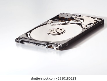 Open internal hard disk drive components showing magnetic platter and read write head