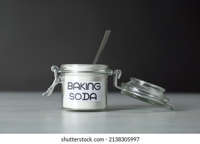 Open Jar With Baking Soda On Grey Table