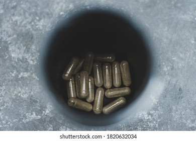 Open Jar Of Nutritional Supplement Pills Shot From Top Down Perspective At Shallow Depth Of Field