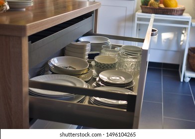 Open Kitchen Drawer Plate Organizer Made Of Metal And Wood Connected To The Kitchen Island; Plates And Bowls  Arrangement