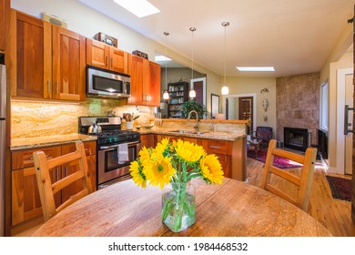 Open Kitchen Wide Shot With Yellow Sunflowers, Fireplace, Living Room, Bookcase In A Secluded Wine Country Home