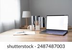 Open laptop with blank screen on a wooden desk in a kitchen room home office	