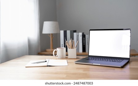 Open laptop with blank screen on a wooden desk in a kitchen room home office	 - Powered by Shutterstock