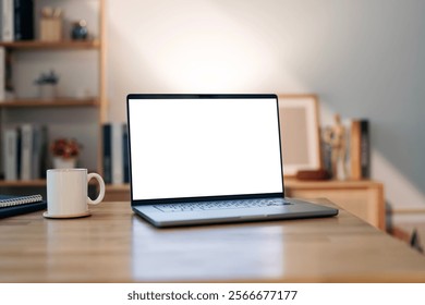 Open laptop with blank screen on a wooden desk in a home office