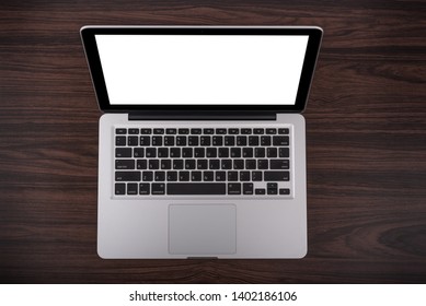 Open laptop with isolated screen on old wooden desk