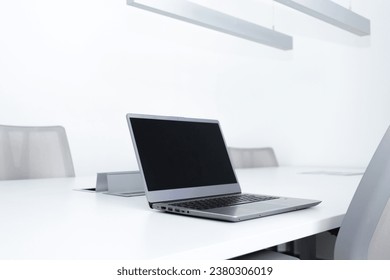 Open laptop on shared work table. Cowork concept.