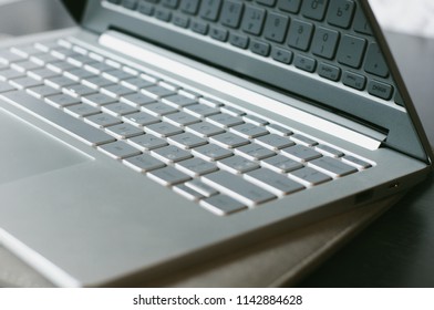 Open laptop on the table. Computer keyboard close-up