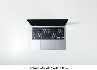 Open laptop on white background, top view