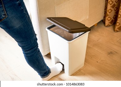 Open the lid with your foot on the trash can pedal