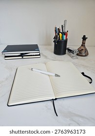Open Lined Notebook With Pen On Marble Desk