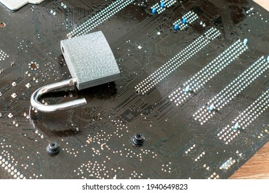 the open lock lies on the computer's motherboard the concept of information protection data hacking. High quality photo