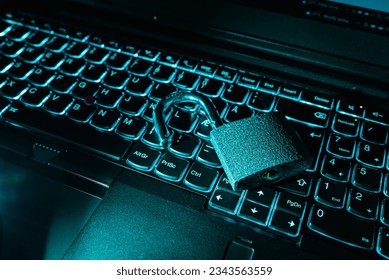 Open lock on keyboard.Hacker attack,padlock on computer keyboard,symbol of cyber security information leak concept.Closeup,selective focus,toned,indoors shot.