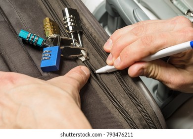 Open a locked suitcase zipper with a ballpoint pen - Shutterstock ID 793476211