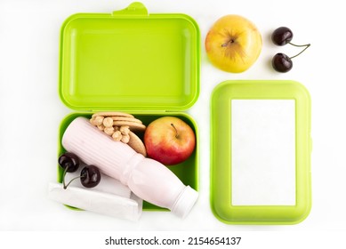 Open Lunchbox With Yogurt, Cookies, Fruits And Nuts And A Closed Lunchbox On A White Background.Lunch Box With Space For Writing Text.