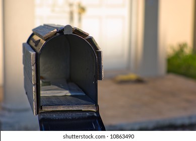 Open Mailbox In Front Of Abandoned House.