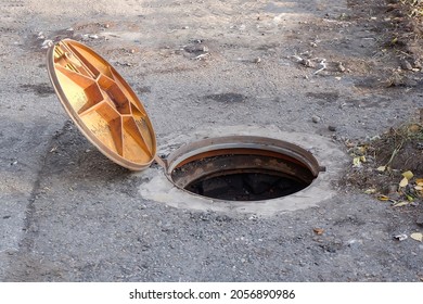 An Open Manhole Cover On The Road.violation Of Safety Regulations. An Accident