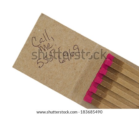 An open matchbook with call me message and generic phone number.