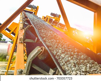 Open mines and processing plants for grinding sandstone and gravel to be used in the road and construction industry, and the evening sun.