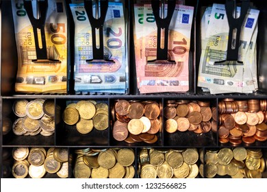 Open Money Drawer Of A Register In A European Small Business. Top View Of Bills Organized Into Slots Of A Cash Tray, With Banknotes Of 50, 20, 10 And 5 Euros, And Coins Of All Euro Zone Denominations