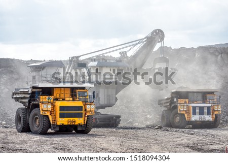Open mountain quarry. Loading coal into a mining truck. Shipment of mountain masyy from the face. Mining in quarry vehicles.