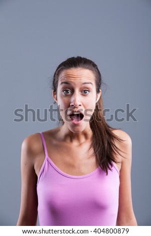 open mouth young girl looking shocked for a surprise and has big eyes even if she's beautiful she looks funny