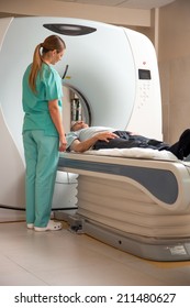 Open MRI Scanner With Man In 40s Undergoing Test.