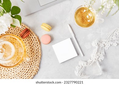 Open note template, herbal tea and laptop. Remote work, to do list, shopping list concept. Aesthetic tea time, flat lay, cozy home. Copy space.