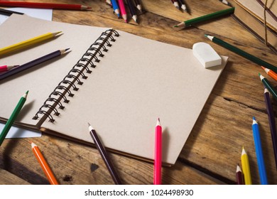 Open Notebook, Blank Paper Sheet, Colored Pencils on the Old Wooden Table. - Powered by Shutterstock