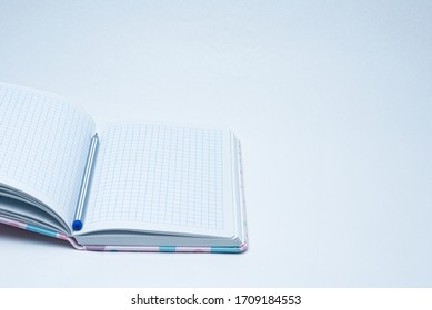 open notebook in a cage with a pen