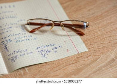 an open notebook with examples are on the table
