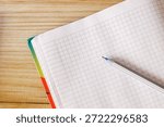 An open notebook on a table intended for study or business with pen