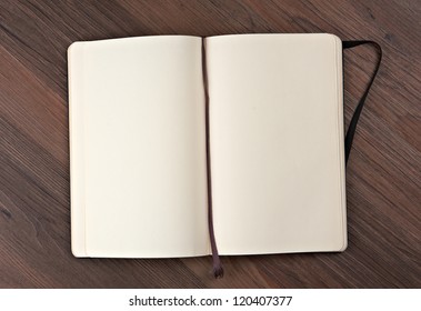 Open Notebook On A Wooden Table