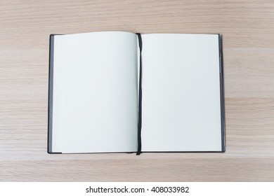 Open Notebook On A Wooden Table, Top View