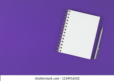 Open Notebook With Pen On The Violet Background, School Notebook On The Purple Desk, Office Desk With Notebook