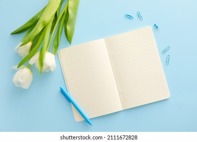 Open Notebook, Pen And Tulips On Color Background
