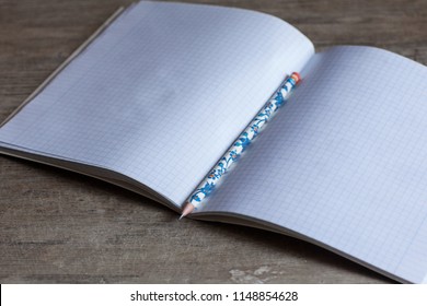 Open notebook and pencil
